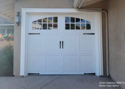 This image shows elegant white garage doors with windows, enhancing the overall aesthetic appeal